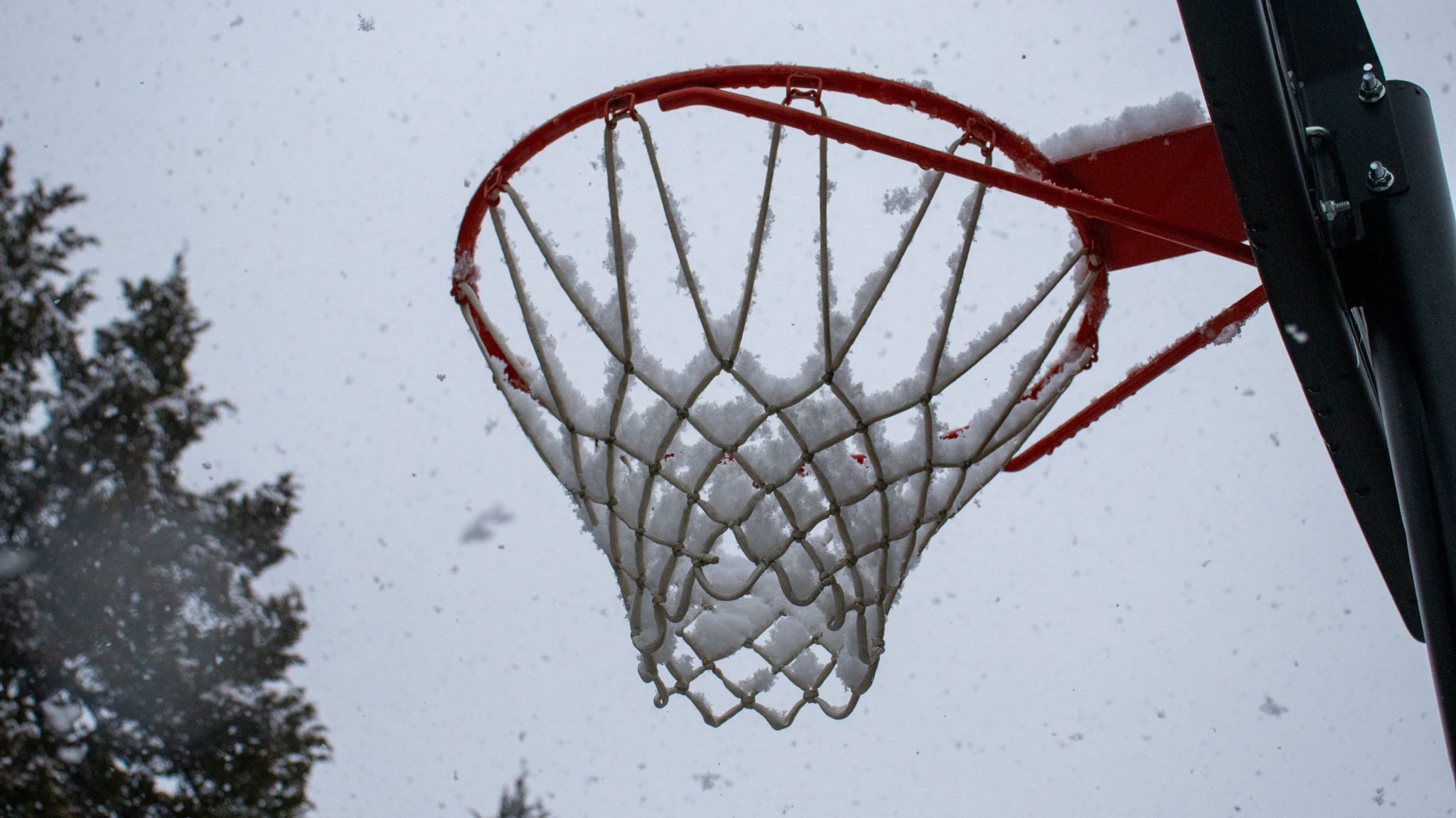 snow on a basketball hoop
